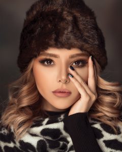 women in a fur hat with winter makeup