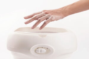Woman in nail salon having paraffin bath