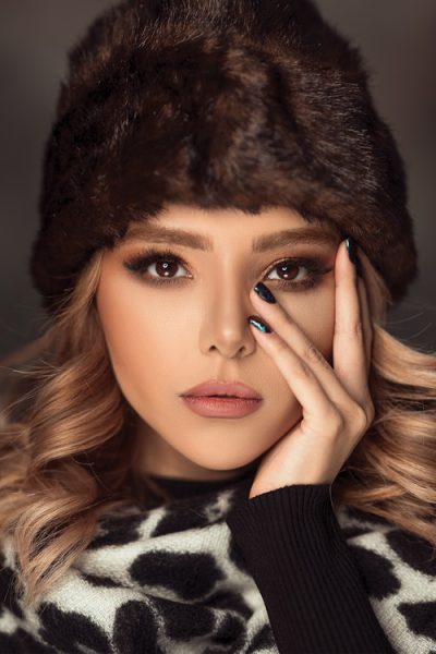 women in a fur hat with winter makeup
