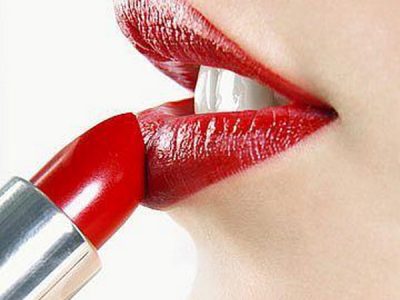 women applying red lipstick