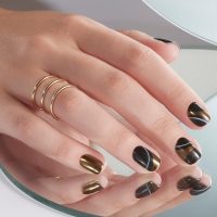 womens hand with chrome nail design
