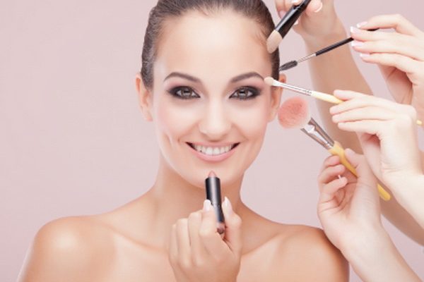 woman having her makeup applied