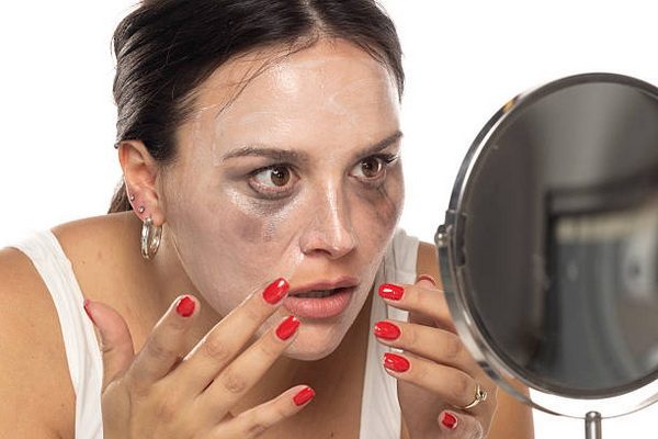 dark haired woman removing her makeup