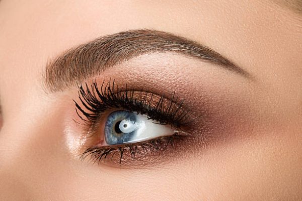 Close up of a woman with blue eyes wearing neutral eyeshadow shades